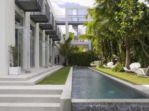 Modern house architecture with a pool and garden - 1 Kind Design Miami.jpg